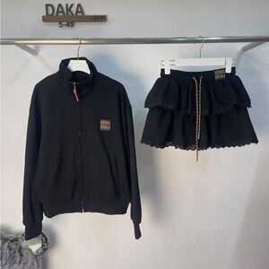 Miu Miu zip-up hooded coat and cake skirt set